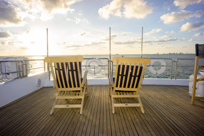 Slide: The Image of Deck chairs on Azimut 98 Leonardo yacht, 2006, overlooking ocean at sunset. - 49