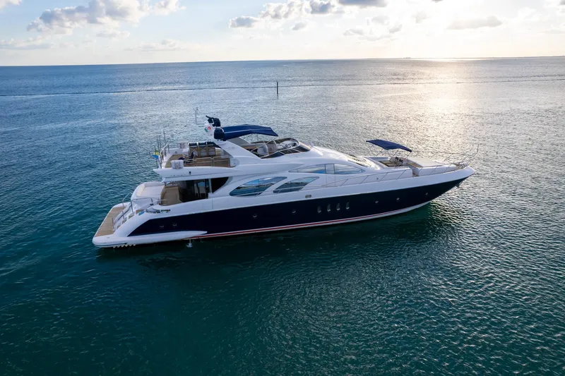 Slide: The Image of Luxury 2006 Azimut 98 Leonardo yacht cruising on serene ocean waters at sunset. - 5