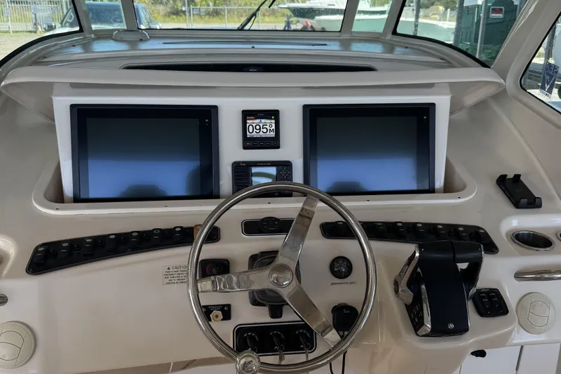 Slide: The Image of Control panel of 2015 Grady-White Canyon 376 boat with dual screens and steering wheel. - 4