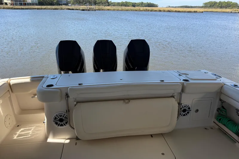 Slide: The Image of 2015 Grady-White Canyon 376 boat with triple outboard motors on a calm lake. - 8