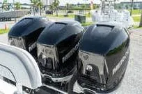 Slide: The Image of Three powerful outboard motors on a 2007 Fountain 38 Tournament Edition boat. - 28