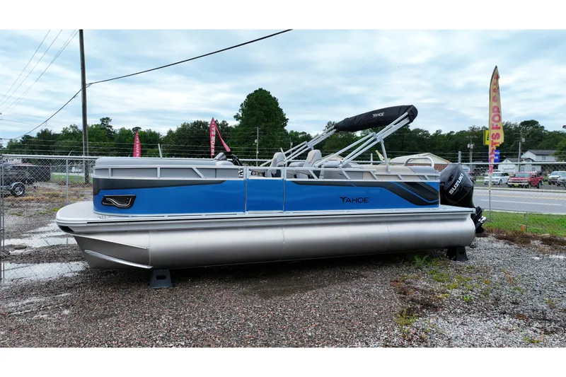 Slide: The Image of 2026 Tahoe Pontoon Sport 85 Quad Lounger, blue and silver, parked outdoors. - 2