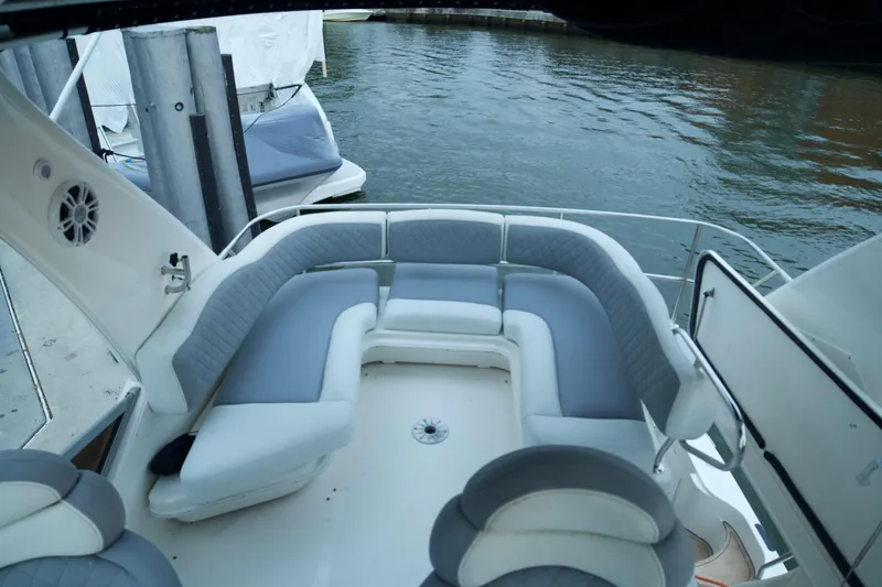 Slide: The Image of 2006 Sea Ray 44 Sedan Bridge yacht with spacious outdoor seating by the water. - 10