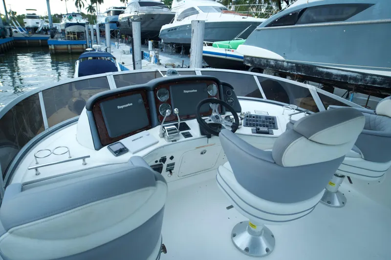 Slide: The Image of 2006 Sea Ray 44 Sedan Bridge helm with dual seats and navigation equipment. - 13
