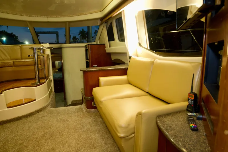 Slide: The Image of Luxurious interior of 2006 Sea Ray 44 Sedan Bridge yacht with beige seating. - 17