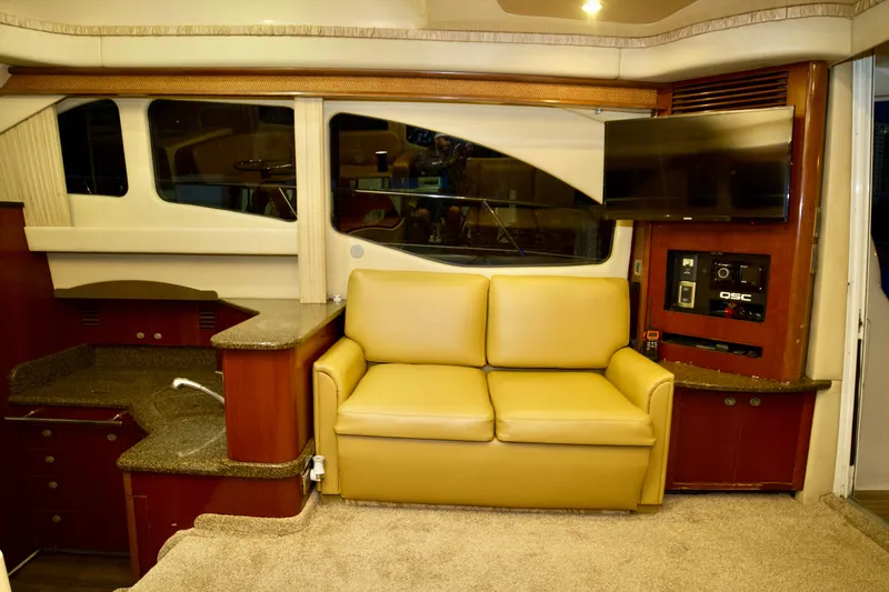 Slide: The Image of Interior of 2006 Sea Ray 44 Sedan Bridge with beige sofa and modern amenities. - 18