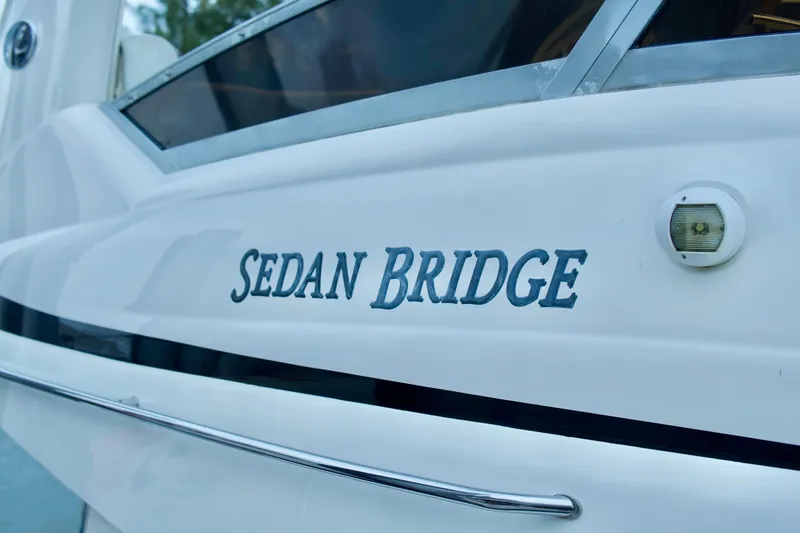 Slide: The Image of 2006 Sea Ray 44 Sedan Bridge yacht, close-up of model name on hull. - 2