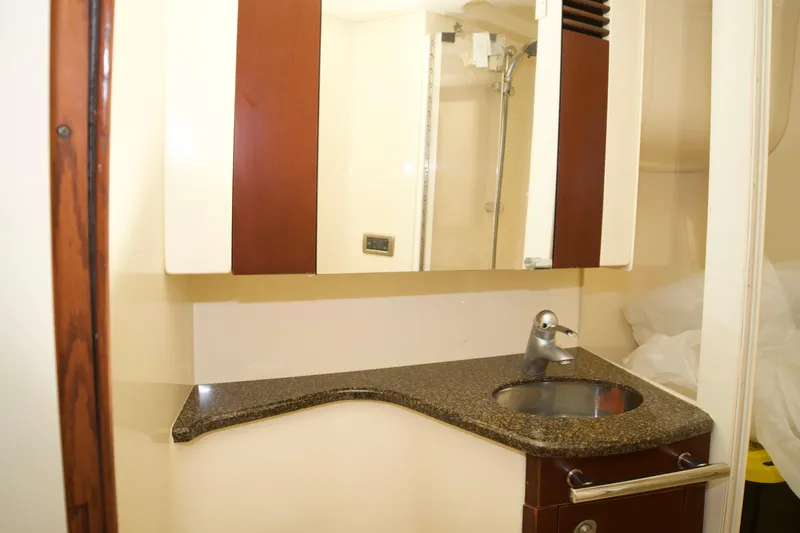 Slide: The Image of 2006 Sea Ray 44 Sedan Bridge bathroom with modern sink and mirror. - 24