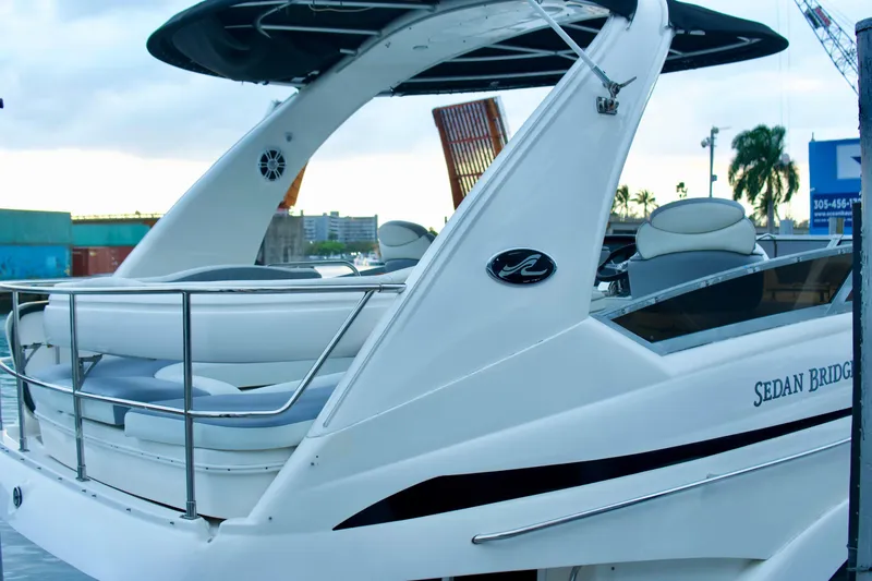 Slide: The Image of 2006 Sea Ray 44 Sedan Bridge yacht docked, showcasing sleek design and spacious deck. - 4