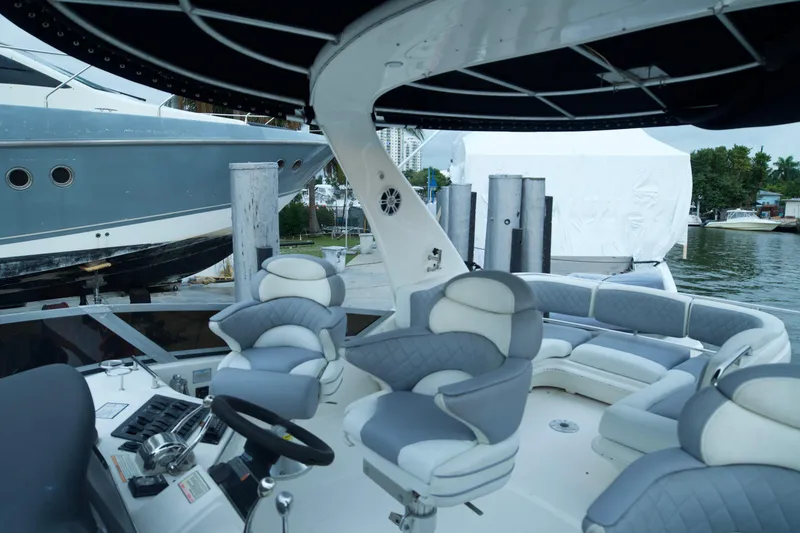 Slide: The Image of 2006 Sea Ray 44 Sedan Bridge yacht interior with plush seating and modern helm controls. - 9