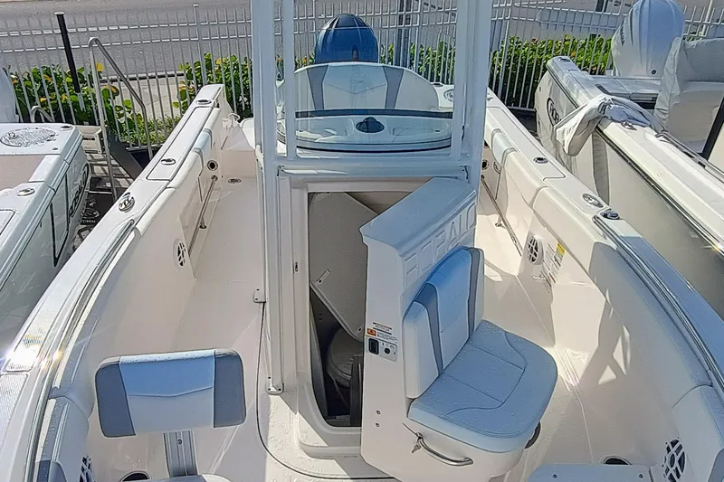 Slide: The Image of 2025 Robalo R230 Center Console boat interior with seating and console view. - 10