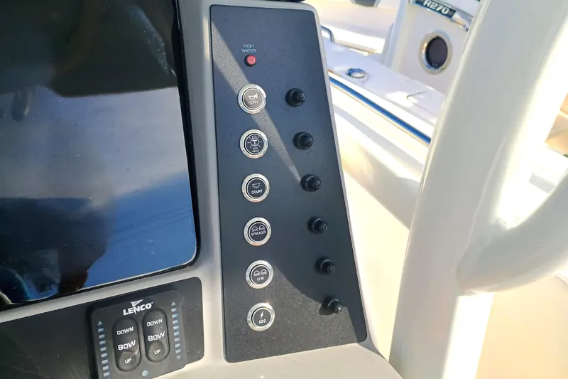 Slide: The Image of Control panel of 2025 Robalo R230 Center Console boat with various switches and indicators. - 15
