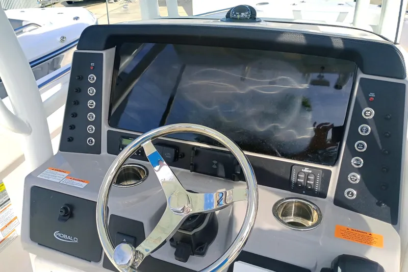 Slide: The Image of 2025 Robalo R230 Center Console dashboard with steering wheel and control panel. - 17