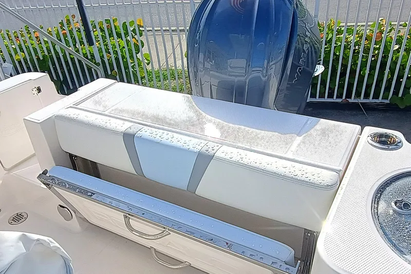 Slide: The Image of 2025 Robalo R230 Center Console boat with cushioned seating and Yamaha engine. - 20