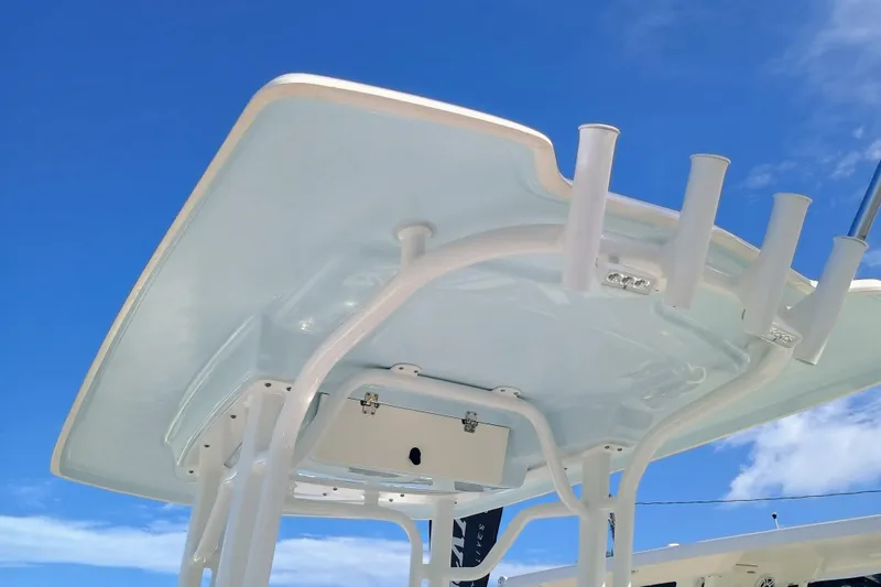 Slide: The Image of 2025 Robalo R230 Center Console boat's T-top against a clear blue sky. - 21