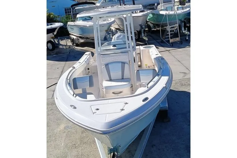 Slide: The Image of 2025 Robalo R230 Center Console boat displayed in a marina setting. - 5