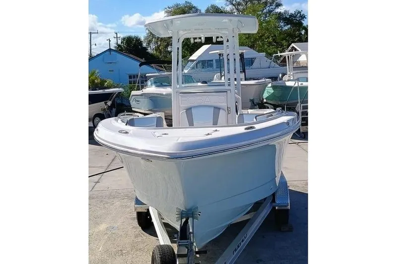 Slide: The Image of 2025 Robalo R230 Center Console boat on trailer, displayed outdoors. - 6