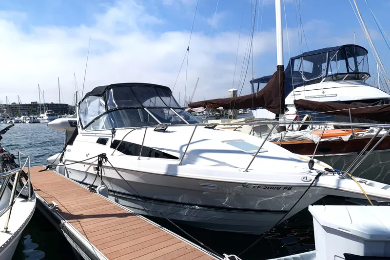 The Image of 1997 Bayliner 2855 Ciera docked at marina, clear sky, calm waters. - 0