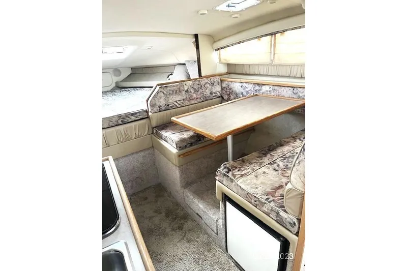 Slide: The Image of 1997 Bayliner 2855 Ciera interior with dining area and cozy seating. - 1