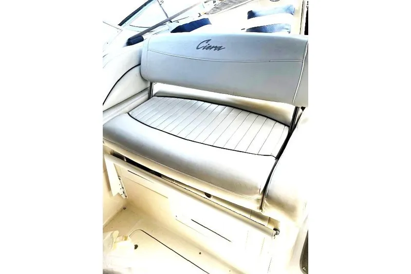 Slide: The Image of 1997 Bayliner 2855 Ciera boat interior with cushioned seating and "Ciera" logo. - 10