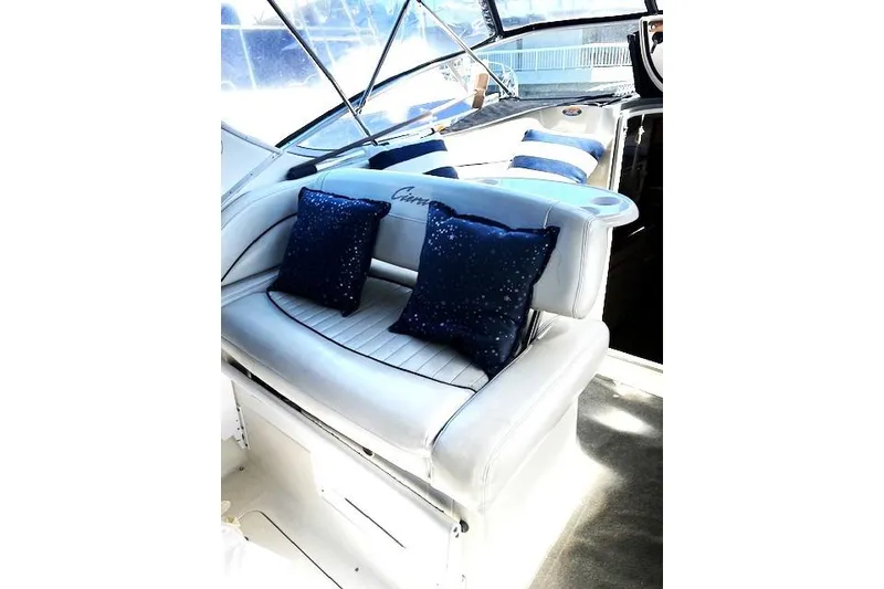 Slide: The Image of Interior of 1997 Bayliner 2855 Ciera boat with cushioned seating and decorative pillows. - 11