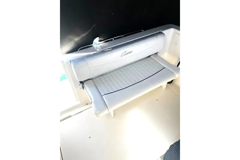 Slide: The Image of 1997 Bayliner 2855 Ciera boat interior with white cushioned seating. - 12