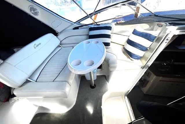 Slide: The Image of Interior of a 1997 Bayliner 2855 Ciera boat with seating and striped cushions. - 13