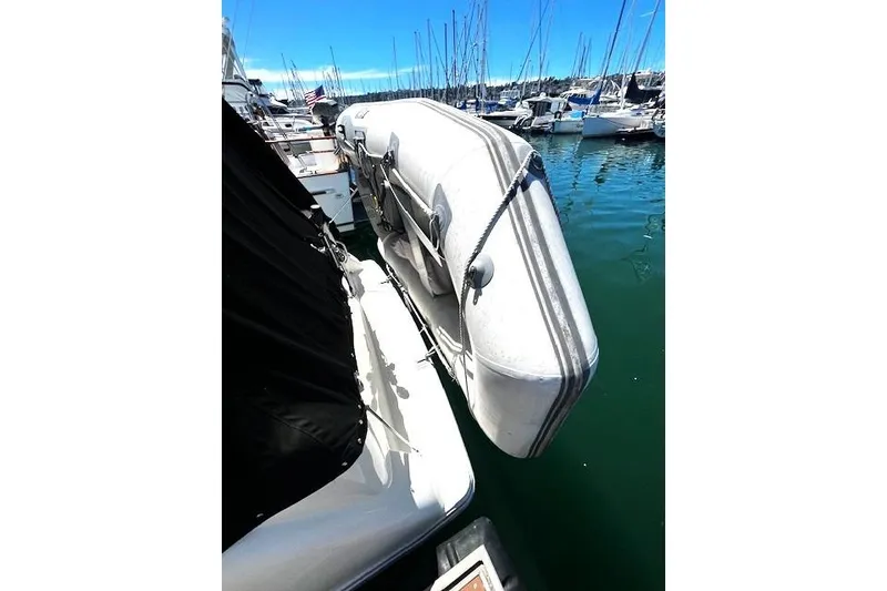 Slide: The Image of 1997 Bayliner 2855 Ciera docked with inflatable dinghy, surrounded by sailboats. - 14