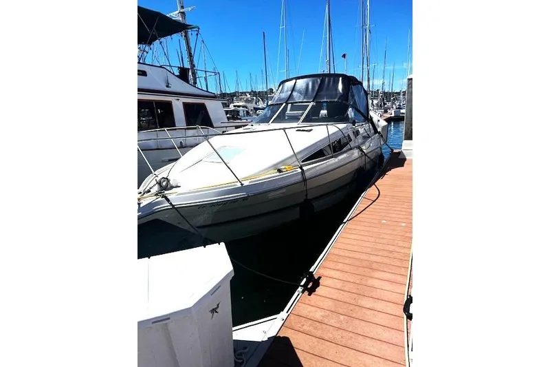 Slide: The Image of 1997 Bayliner 2855 Ciera docked at marina under clear blue sky. - 16