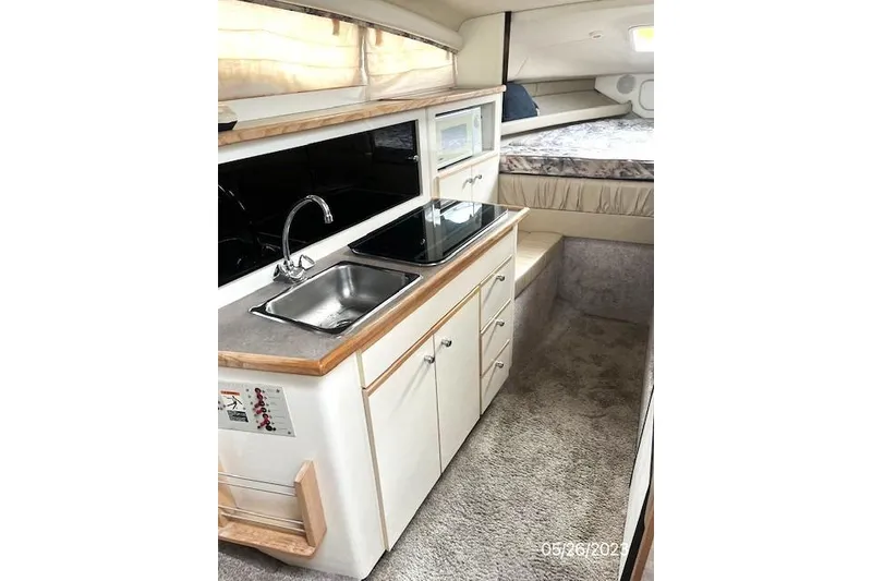 Slide: The Image of Interior of 1997 Bayliner 2855 Ciera boat with kitchenette and sleeping area. - 2