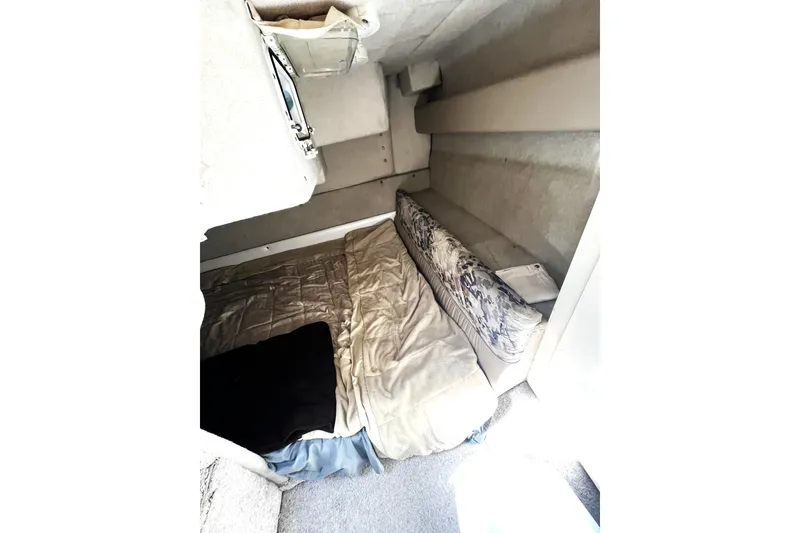 Slide: The Image of 1997 Bayliner 2855 Ciera cabin interior with bed and storage compartments. - 7