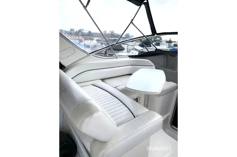 Slide: The Image of 1997 Bayliner 2855 Ciera boat interior with white seating and table. - 8
