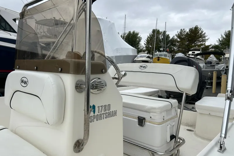 Slide: The Image of 2014 Key West 1720 Center Console boat with white seating and console, docked outdoors. - 6