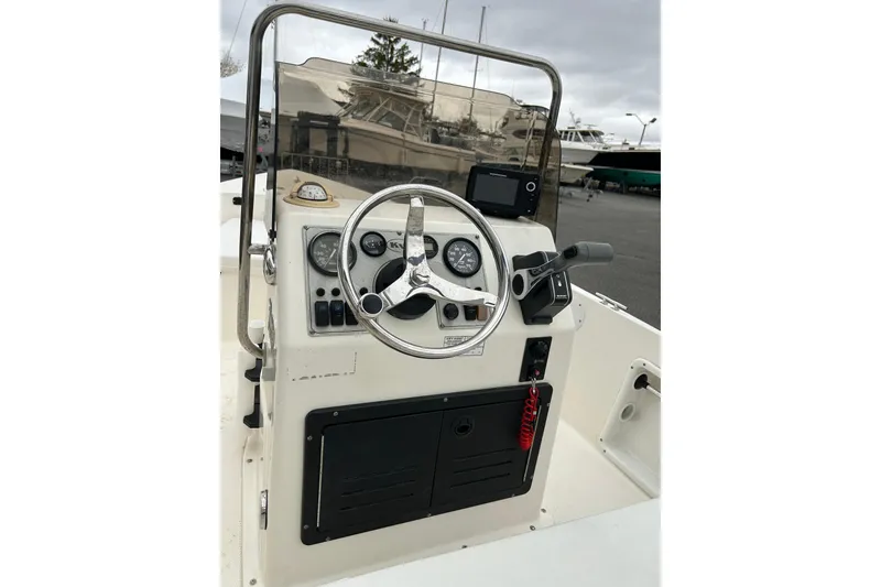 Slide: The Image of 2014 Key West 1720 Center Console boat dashboard with steering wheel and controls. - 8