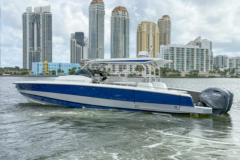 Slide: The Image of 2024 Opus OPUS 12 boat cruising near city skyline with Yamaha engine. - 2