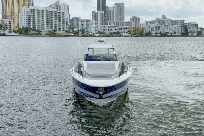 Slide: The Image of 2024 Opus OPUS 12 boat on water with city skyline in background. - 5