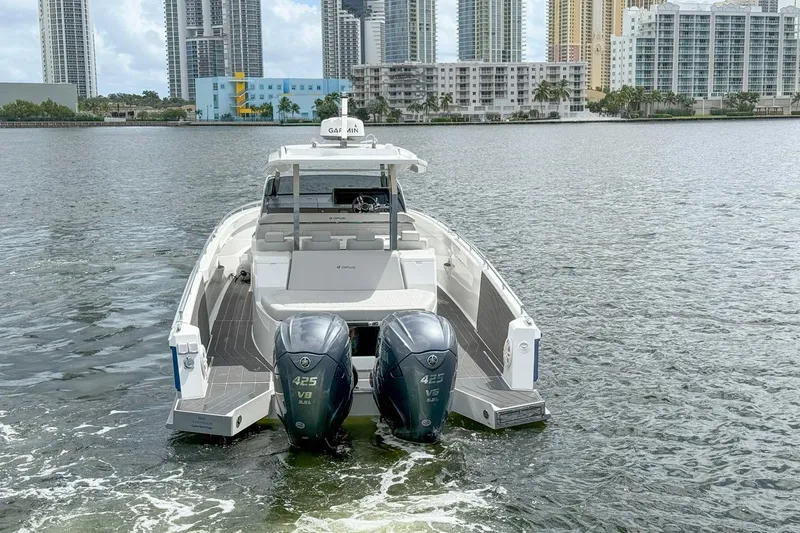 Slide: The Image of 2024 Opus OPUS 12 boat with dual engines on a city waterfront. - 6
