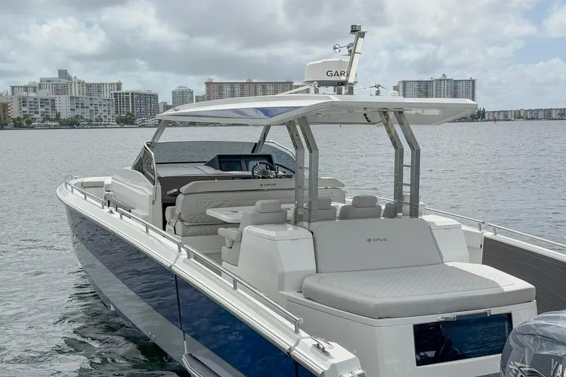 Slide: The Image of Luxury Opus OPUS 12 boat, 2024 model, docked with city skyline in background. - 7