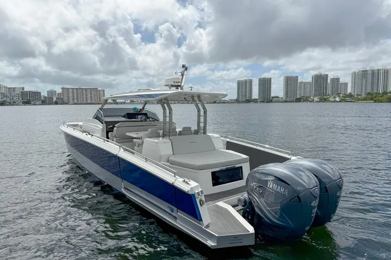 Slide: The Image of 2024 Opus OPUS 12 boat with Yamaha engines on a city waterfront. - 8