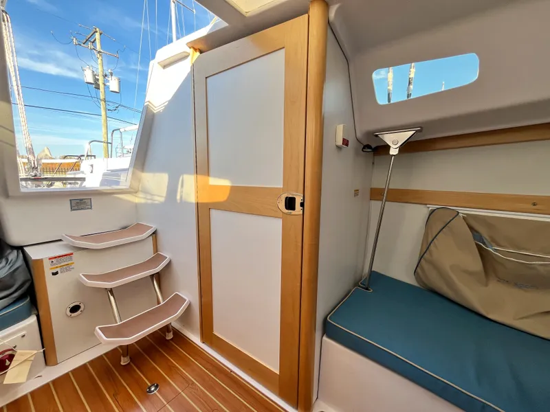 Slide: The Image of Interior of 2021 Catalina 275 Sport with wooden door and seating area. - 23