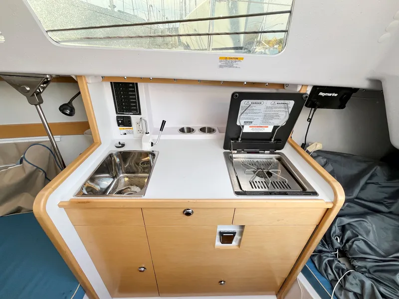 Slide: The Image of Interior of 2021 Catalina 275 Sport featuring kitchenette and sink. - 25