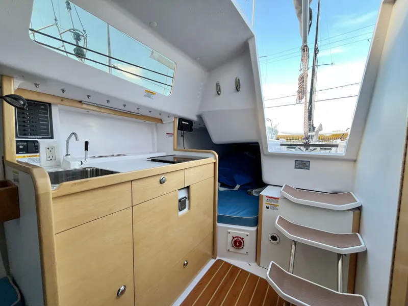 Slide: The Image of Interior of 2021 Catalina 275 Sport with kitchenette and stairs. - 27