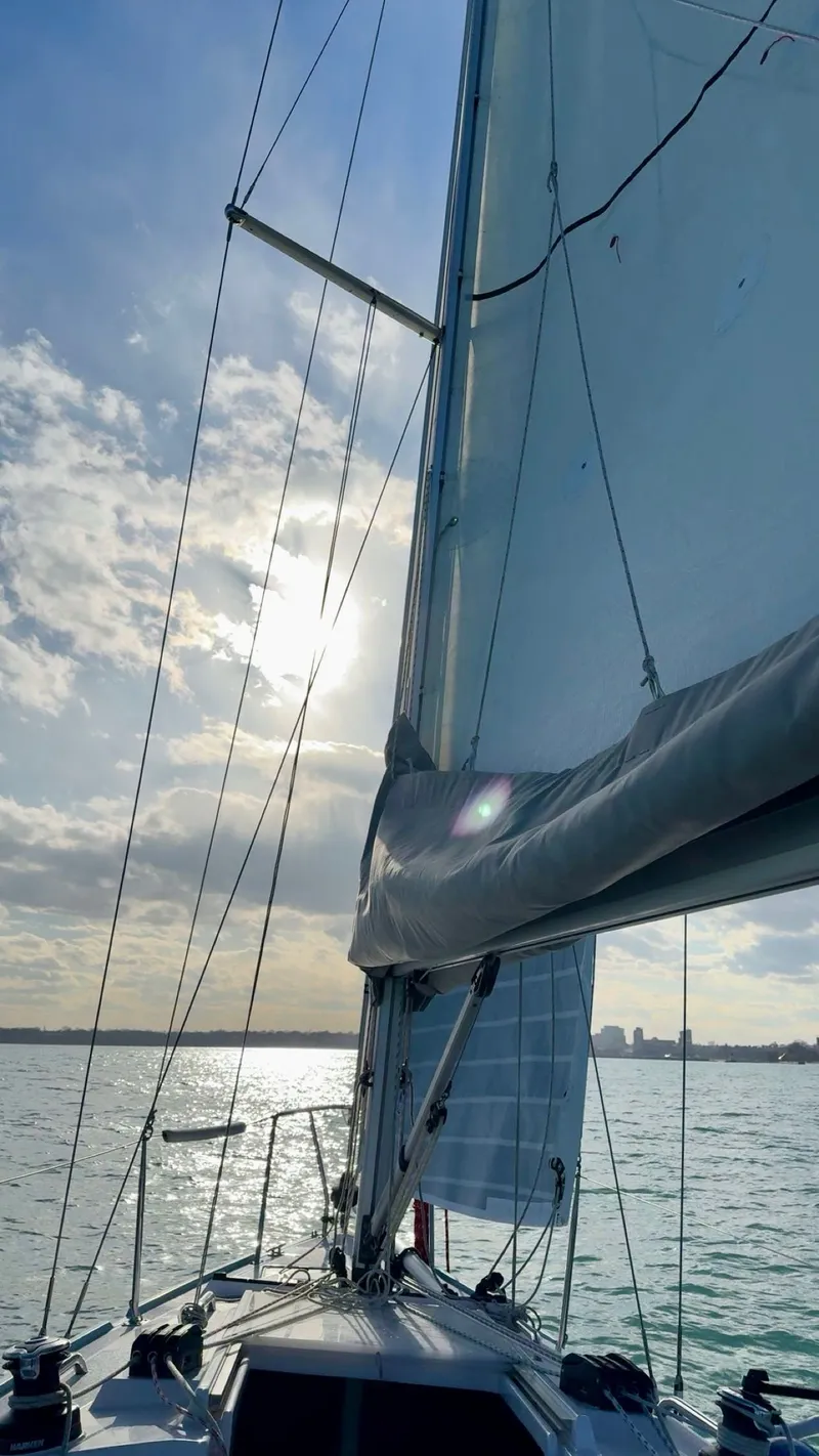 Slide: The Image of Sailing on a 2021 Catalina 275 Sport with sunlit sky and calm waters. - 6