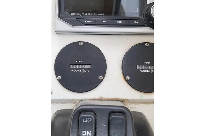 Slide: The Image of Control panel of a 2014 Eastern Islander 270 boat with hour meters and audio system. - 3