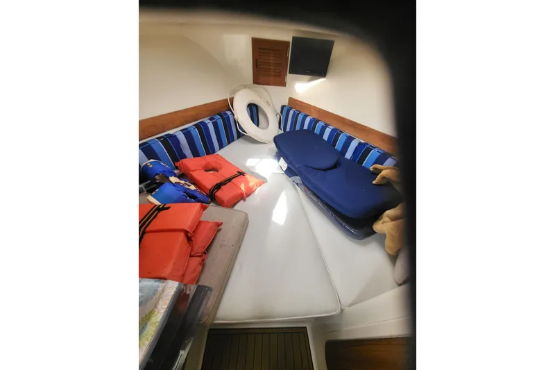 Slide: The Image of 2014 Eastern Islander 270 cabin interior with striped cushions and life jackets. - 6
