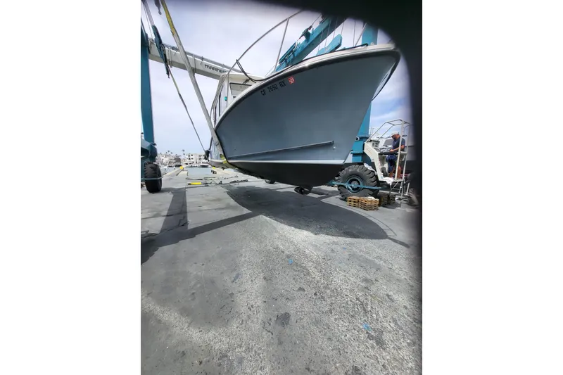 Slide: The Image of 2015 Eastern Islander 270 boat being lifted at a marina. - 7