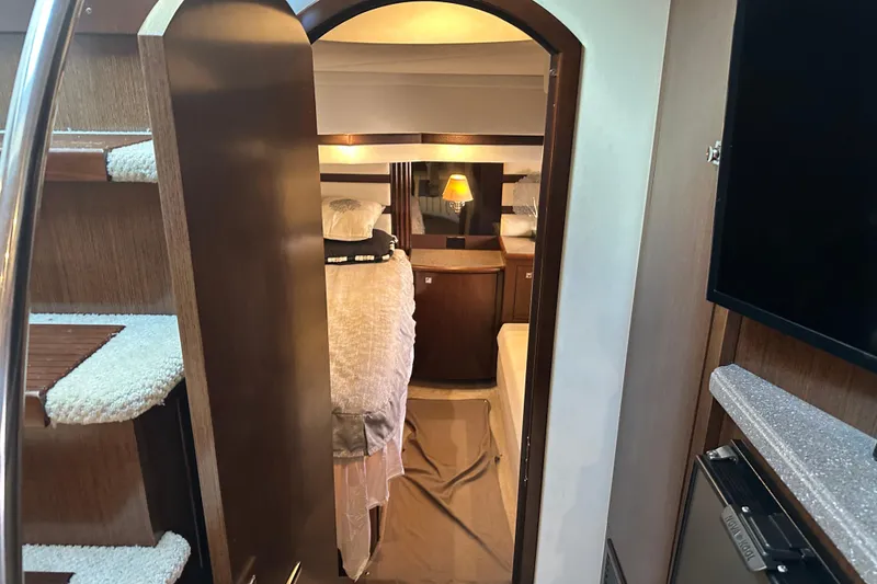 Slide: The Image of Interior of 2011 Cruisers Yachts 540 Sports Coupe, featuring cozy cabin and staircase. - 28