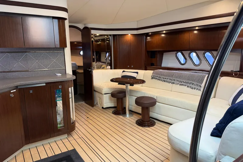 Slide: The Image of Luxurious interior of 2011 Cruisers Yachts 540 Sports Coupe with elegant wood finishes and plush seating. - 56