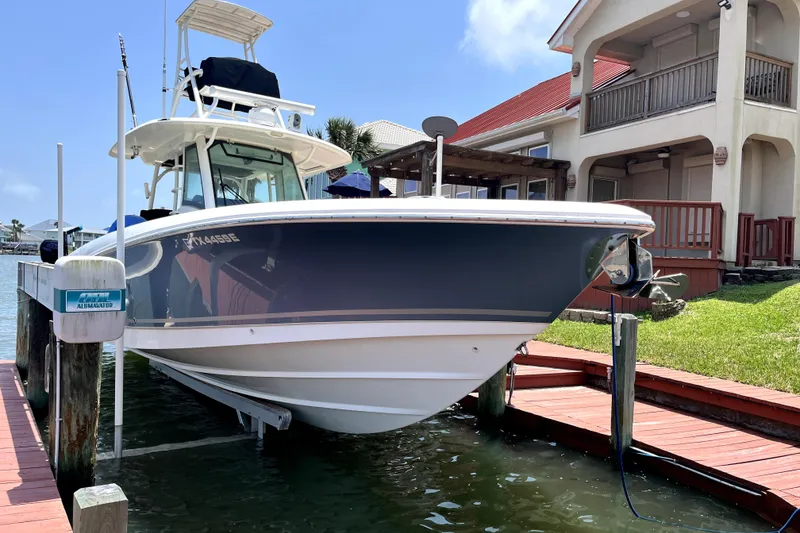 Slide: The Image of 2019 Boston Whaler 330 Outrage docked near waterfront home. - 3