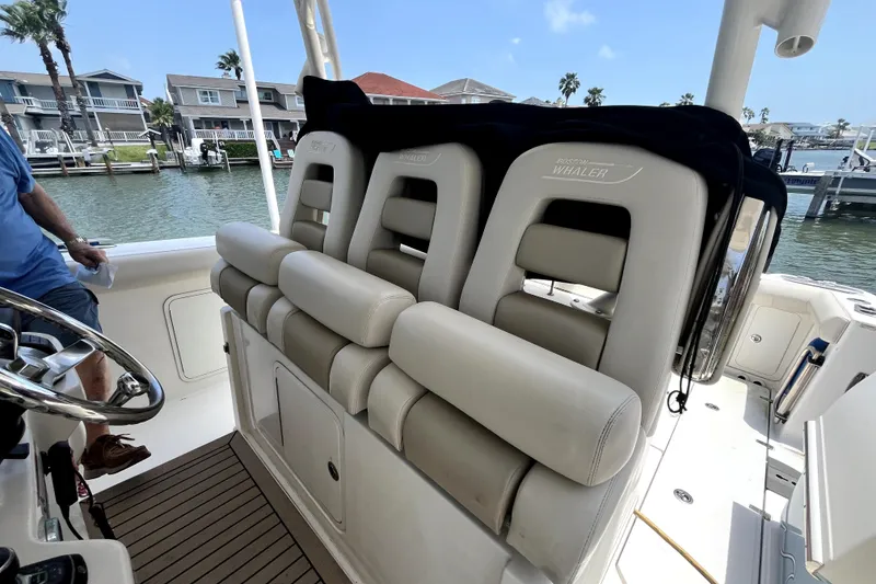 Slide: The Image of 2019 Boston Whaler 330 Outrage boat seats, docked near waterfront homes. - 5